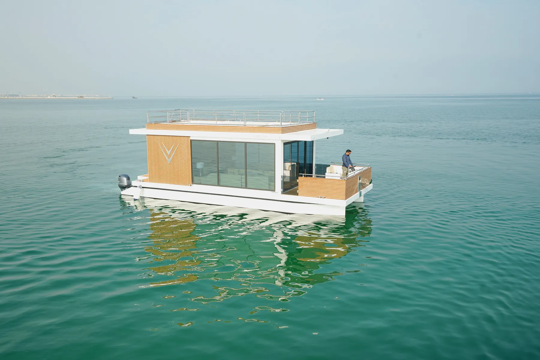 Aquator HotelYacht seen from the water, with its timber V-Marine panel