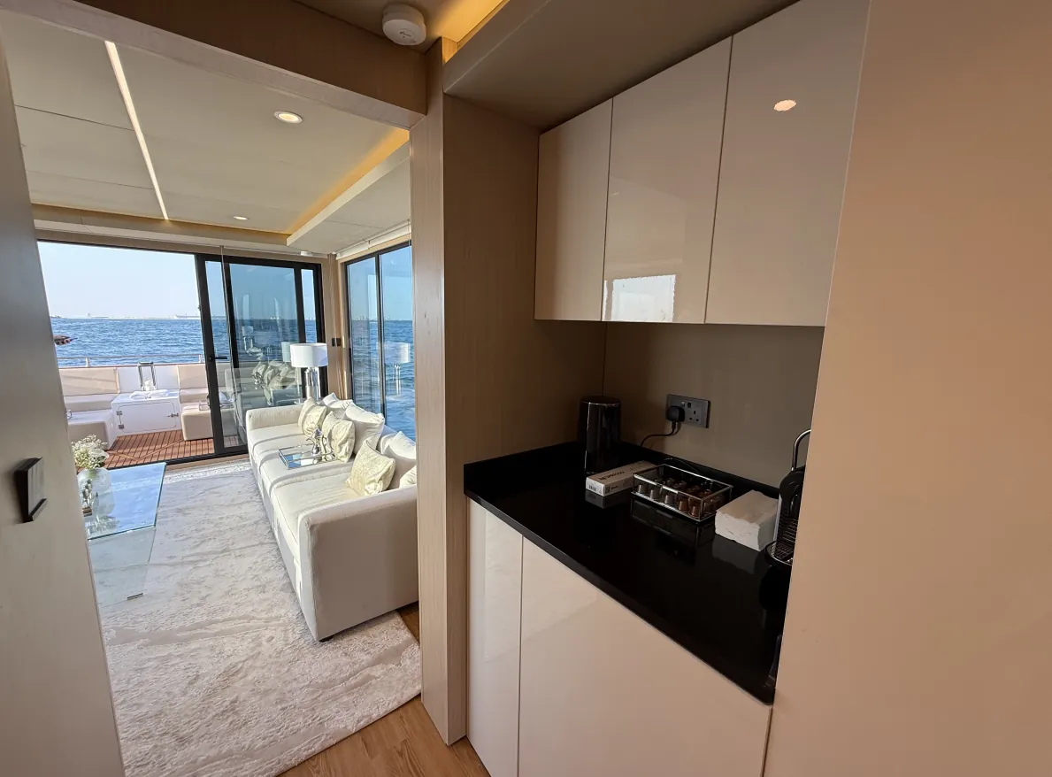 Aquator 28 kitchenette with gloss cabinetry beside the lounge