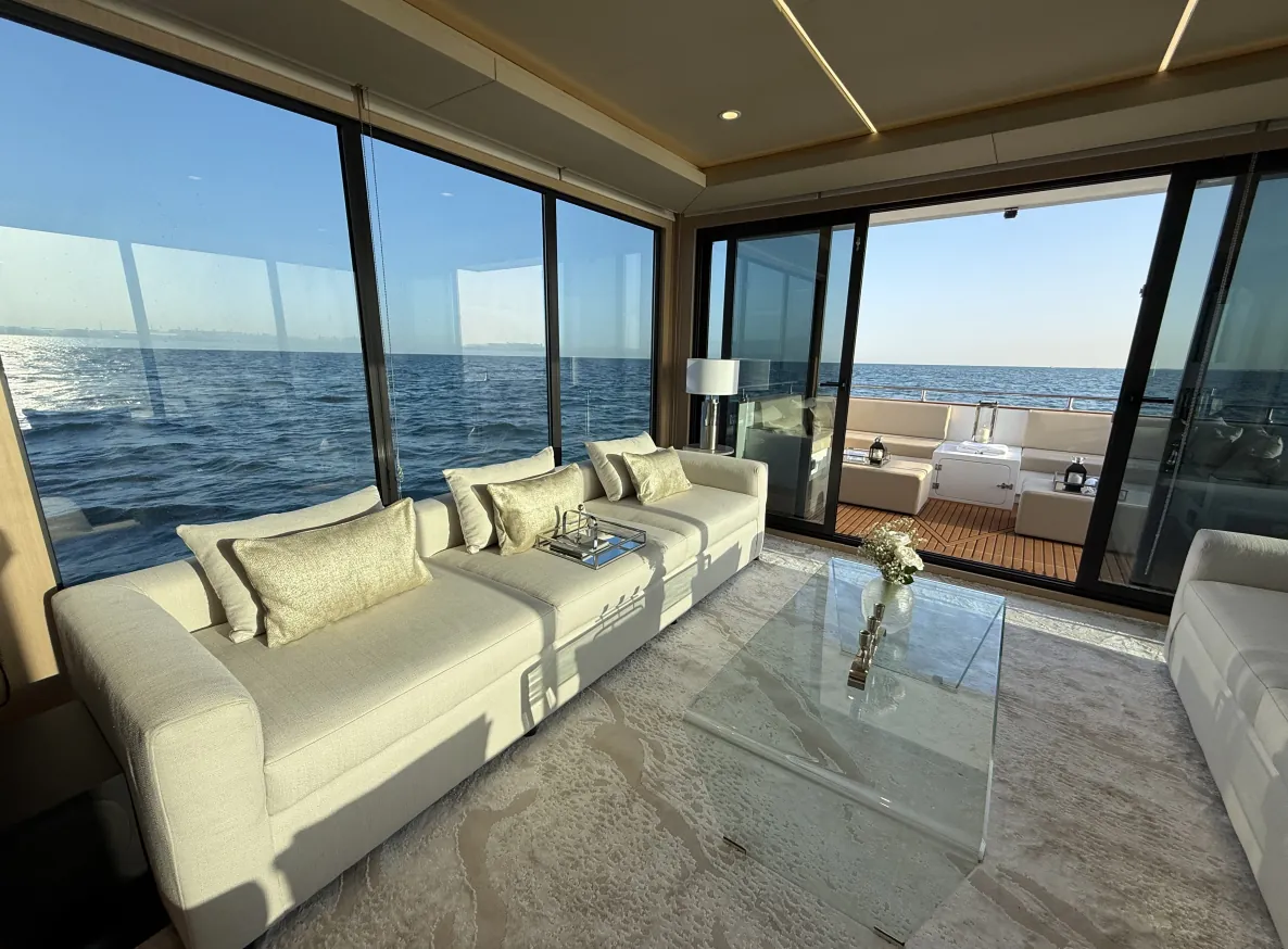 Aquator 28 saloon with cream sofas and glass walls to the sea