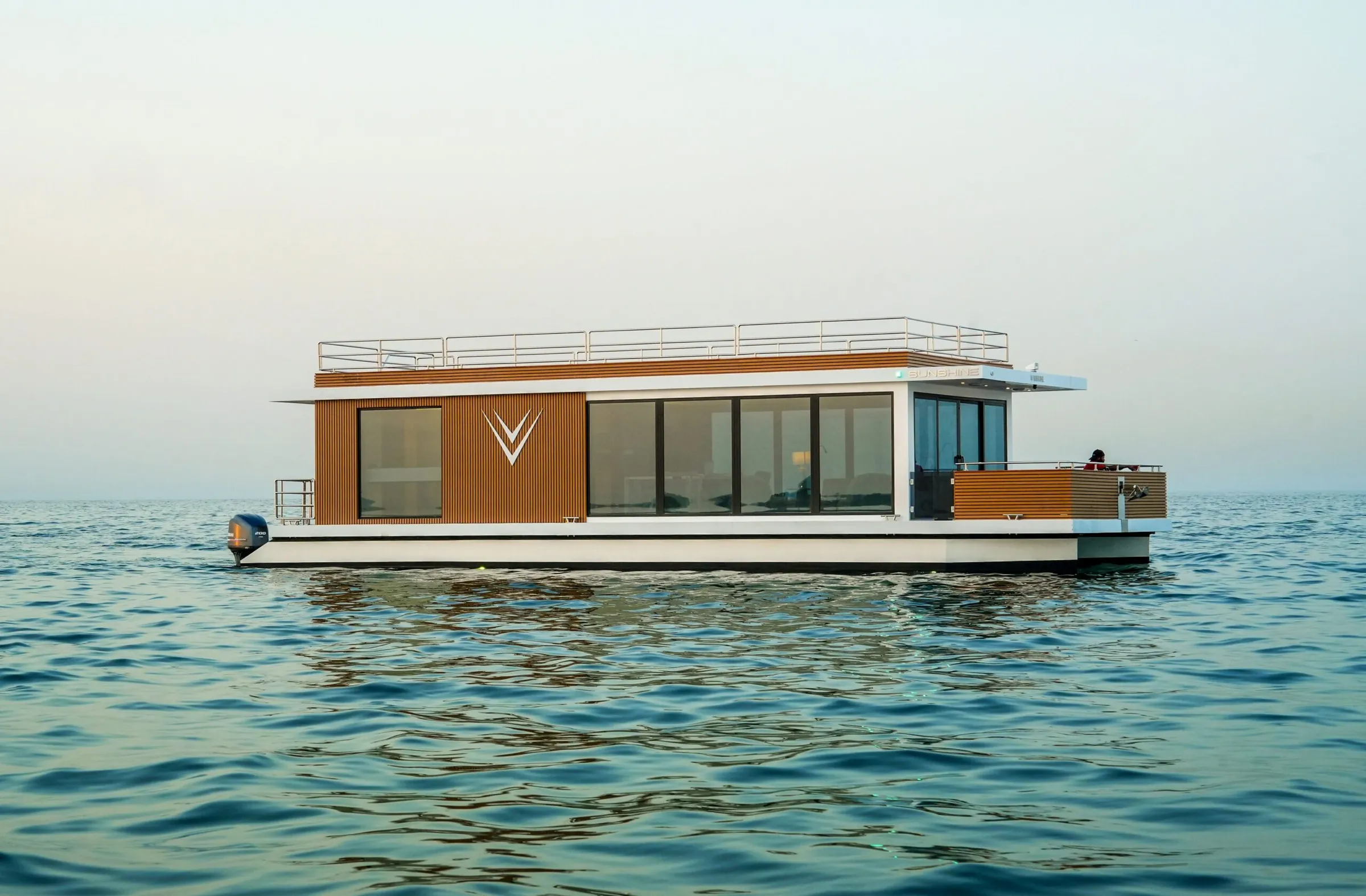 Aquator 42 on calm water with its flybridge and timber-clad cabin