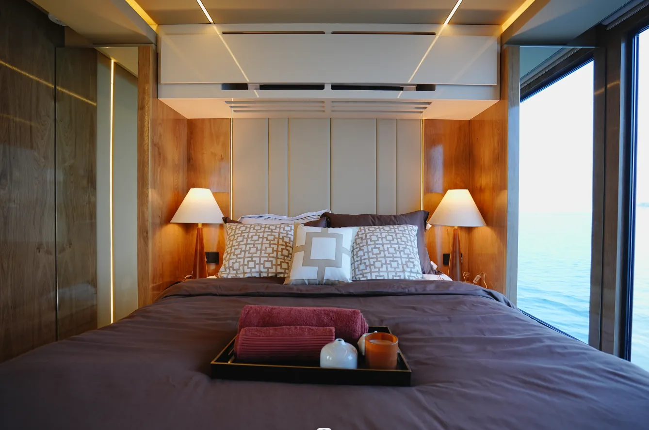 Aquator 50 bedroom with timber panelling and bedside lamps