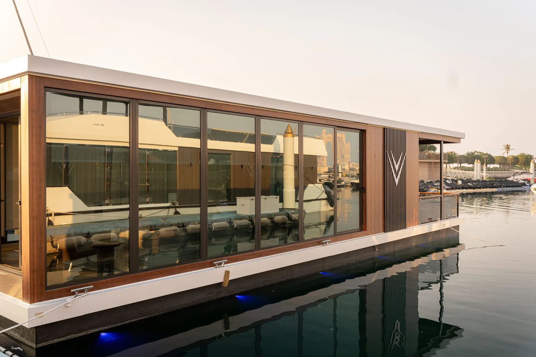 Floating Office with full-height glazing moored in a marina